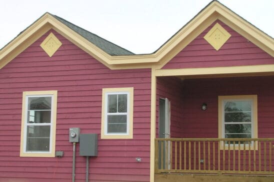 Pink house with yellow trim and front porch