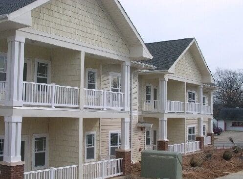 Two-story apartment building with white balconies