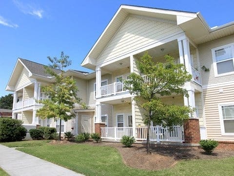 Two-story apartment building with balconies and landscaping