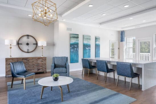Modern living room with blue chairs and wall art