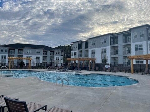 Apartment complex courtyard with swimming pool and lounge chairs
