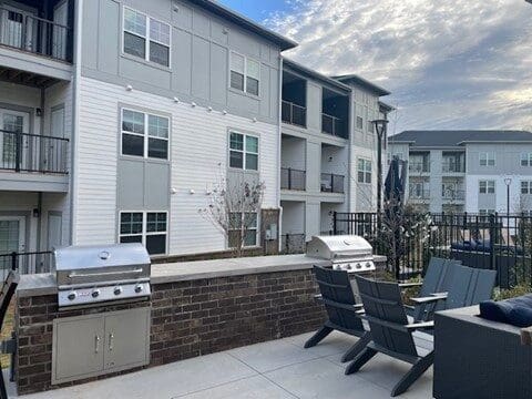 Apartment courtyard with grills and outdoor seating area