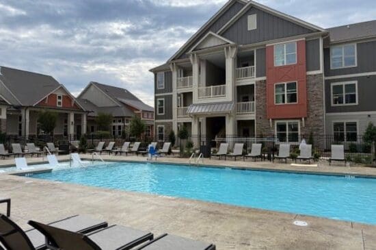 Apartment complex swimming pool with lounge chairs
