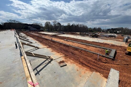 Construction site with concrete foundations and workers